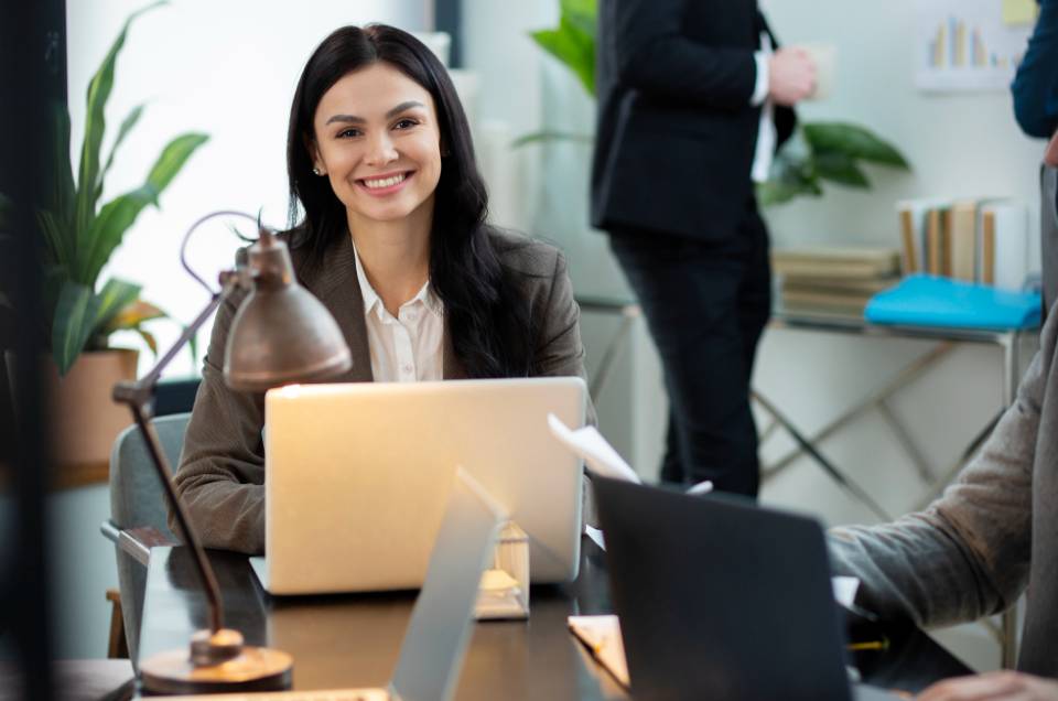 Close up smiley woman with laptop